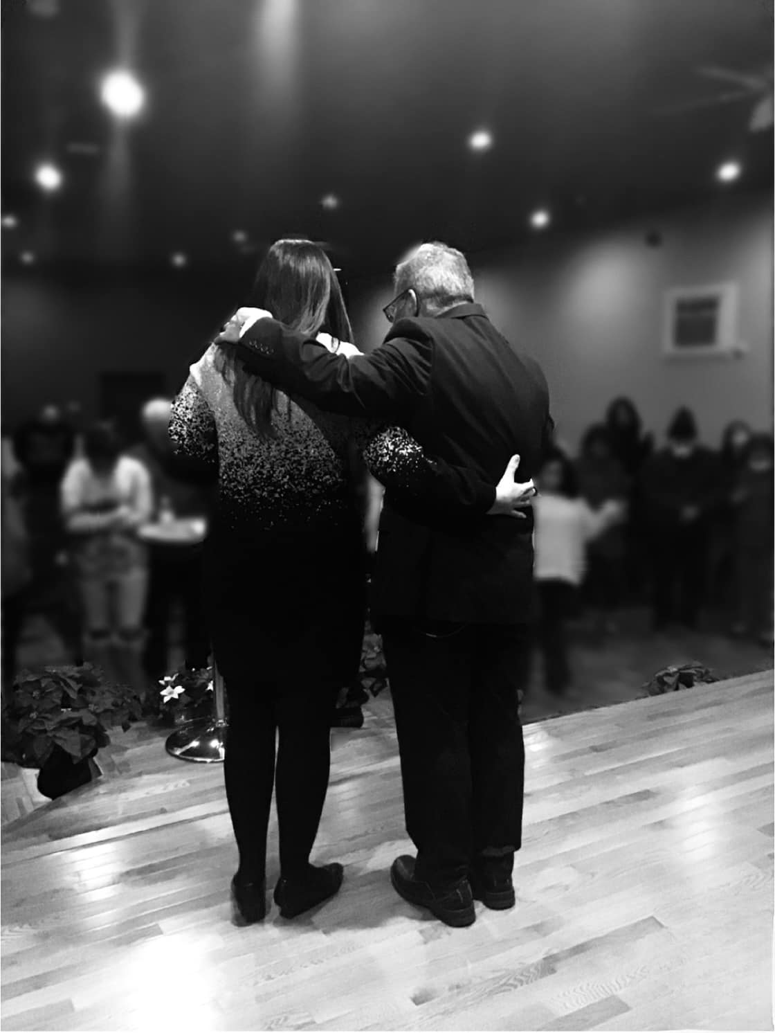 Founding pastors embracing in the church sanctuary - a moment of pastoral care and community